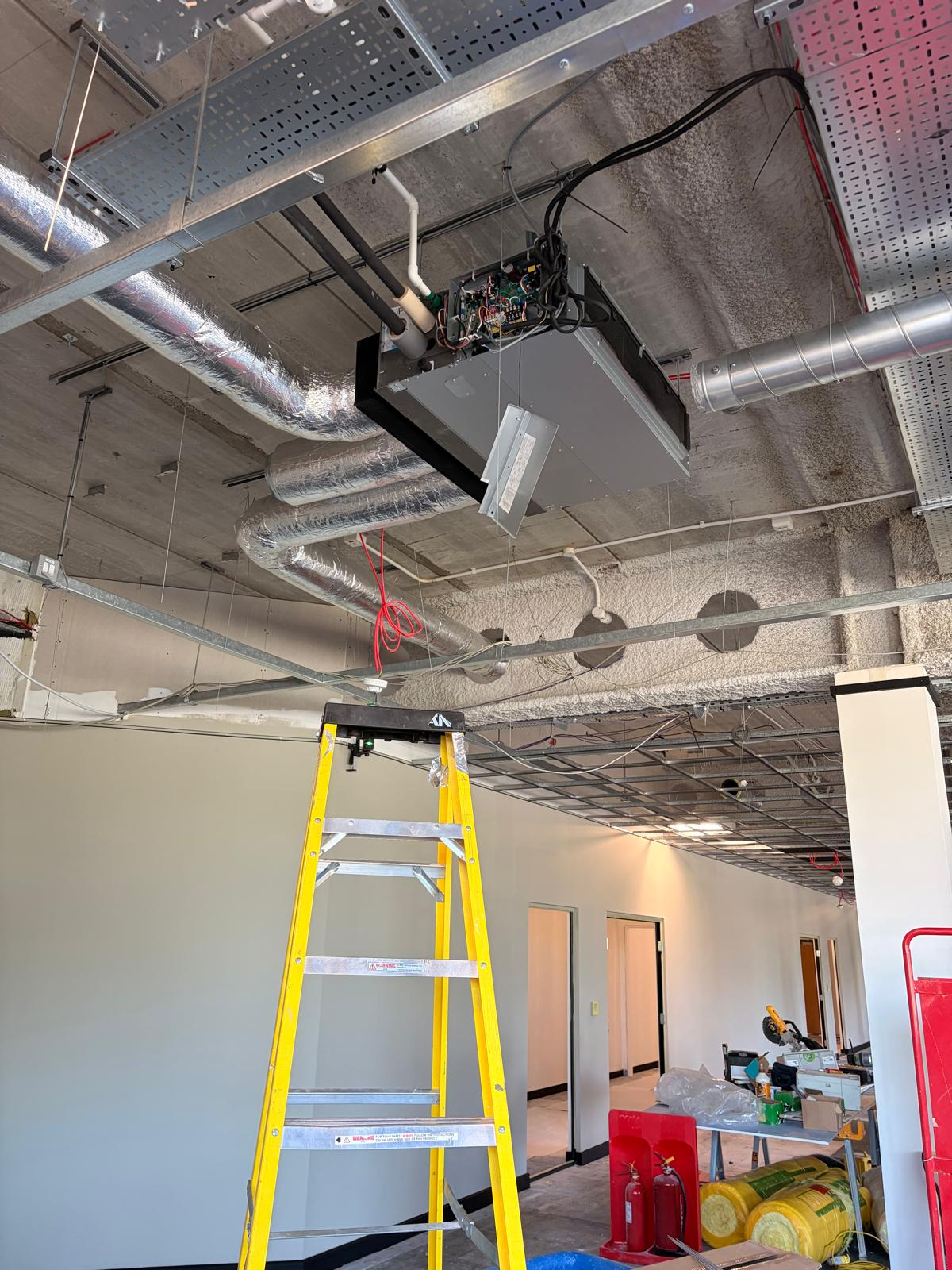 Concealed ceiling unit — first fix during office fit-out